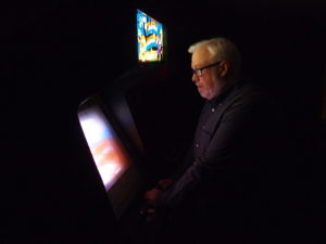 Jamie McDaniel playing Captain America and the Avengers cabinet arcade game.